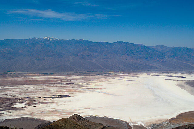 Salt below, and in the background – snow on the Sierra Nevada mountains / View from Dante's View of Badwater